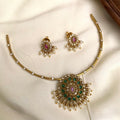 Gold necklace with green and pink stones