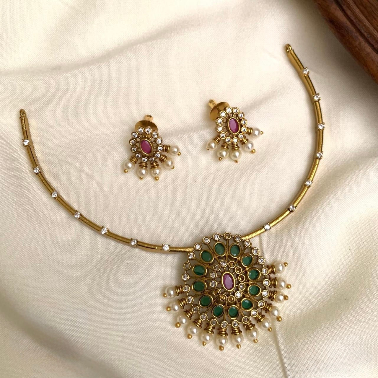 Gold necklace with green and pink stones